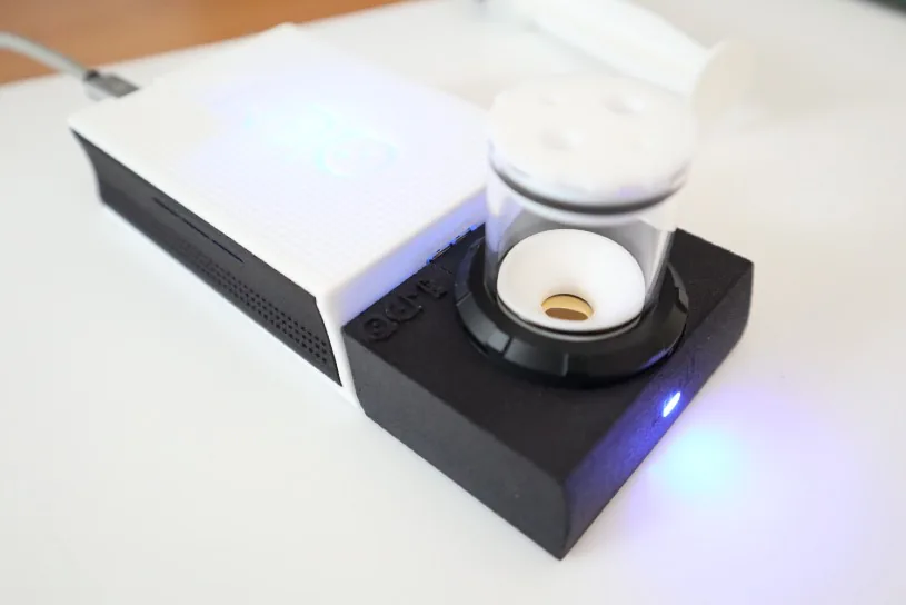 The electrochemistry module for openQCM Q-1 mounted on the instrument: quartz chamber, PTFE cover, the blue LED on